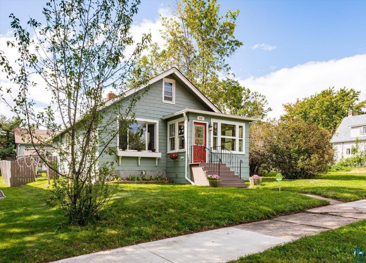 Bungalow-style house with a front lawn