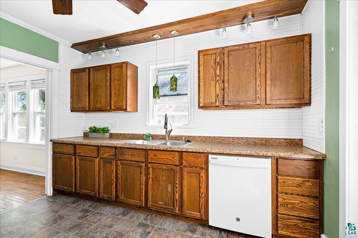 519 3rd Avenue Proctor, MN 55810 - Photo 12 of 25 Kitchen with crown molding, dark hardwood / wood-style flooring, white dishwasher, ceiling fan, and sink