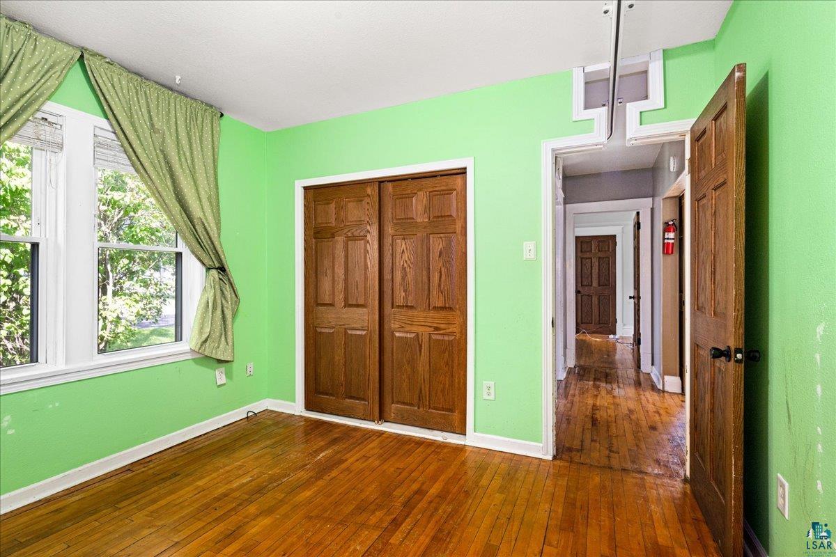 519 3rd Avenue Proctor, MN 55810 - Photo 15 of 25 Unfurnished bedroom featuring dark wood-type flooring and a closet