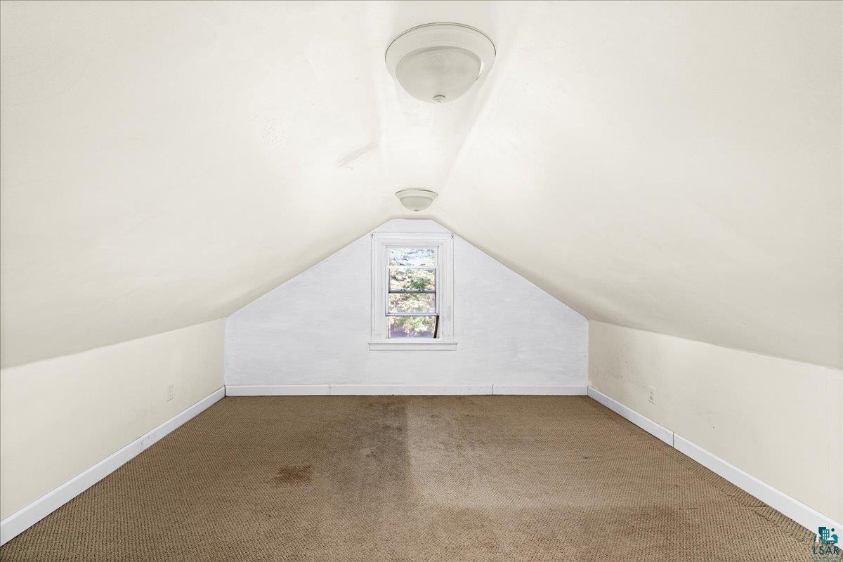 519 3rd Avenue Proctor, MN 55810 - Photo 17 of 25 Additional living space featuring vaulted ceiling and carpet flooring