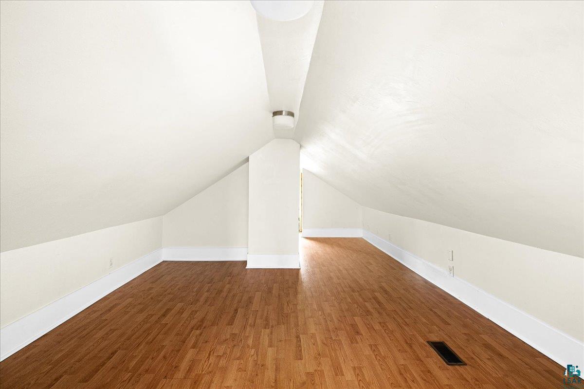 519 3rd Avenue Proctor, MN 55810 - Photo 18 of 25 Bonus room with wood-type flooring and vaulted ceiling