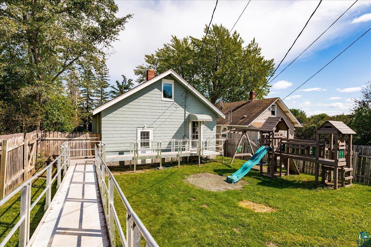 519 3rd Avenue Proctor, MN 55810 - Photo 23 of 25 Rear view of property with a playground and a lawn