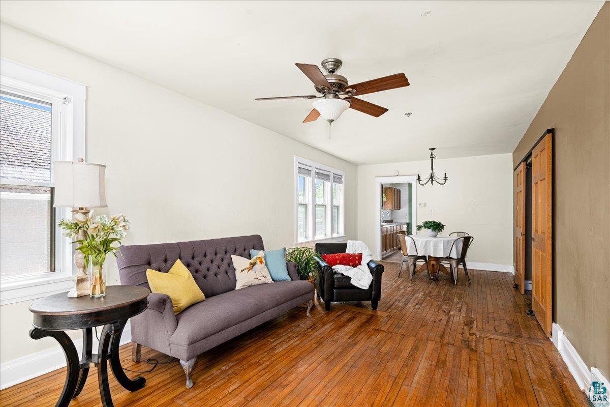519 3rd Avenue Proctor, MN 55810 - Photo 6 of 25 Living room featuring ceiling fan with notable chandelier and dark hardwood / wood-style flooring