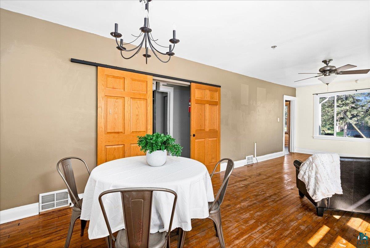 519 3rd Avenue Proctor, MN 55810 - Photo 8 of 25 Dining area featuring ceiling fan with notable chandelier and dark hardwood / wood-style floors