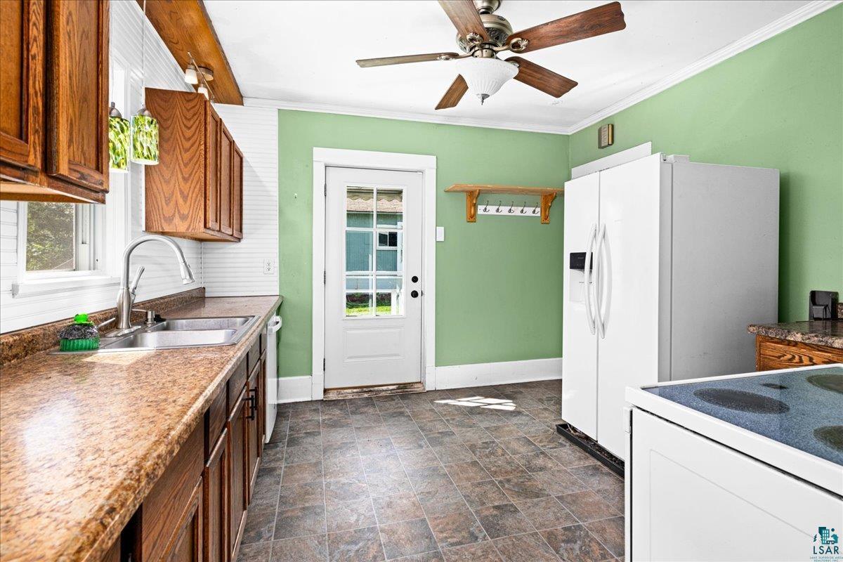 519 3rd Avenue Proctor, MN 55810 - Photo 10 of 25 Kitchen with crown molding, ceiling fan, sink, and white appliances