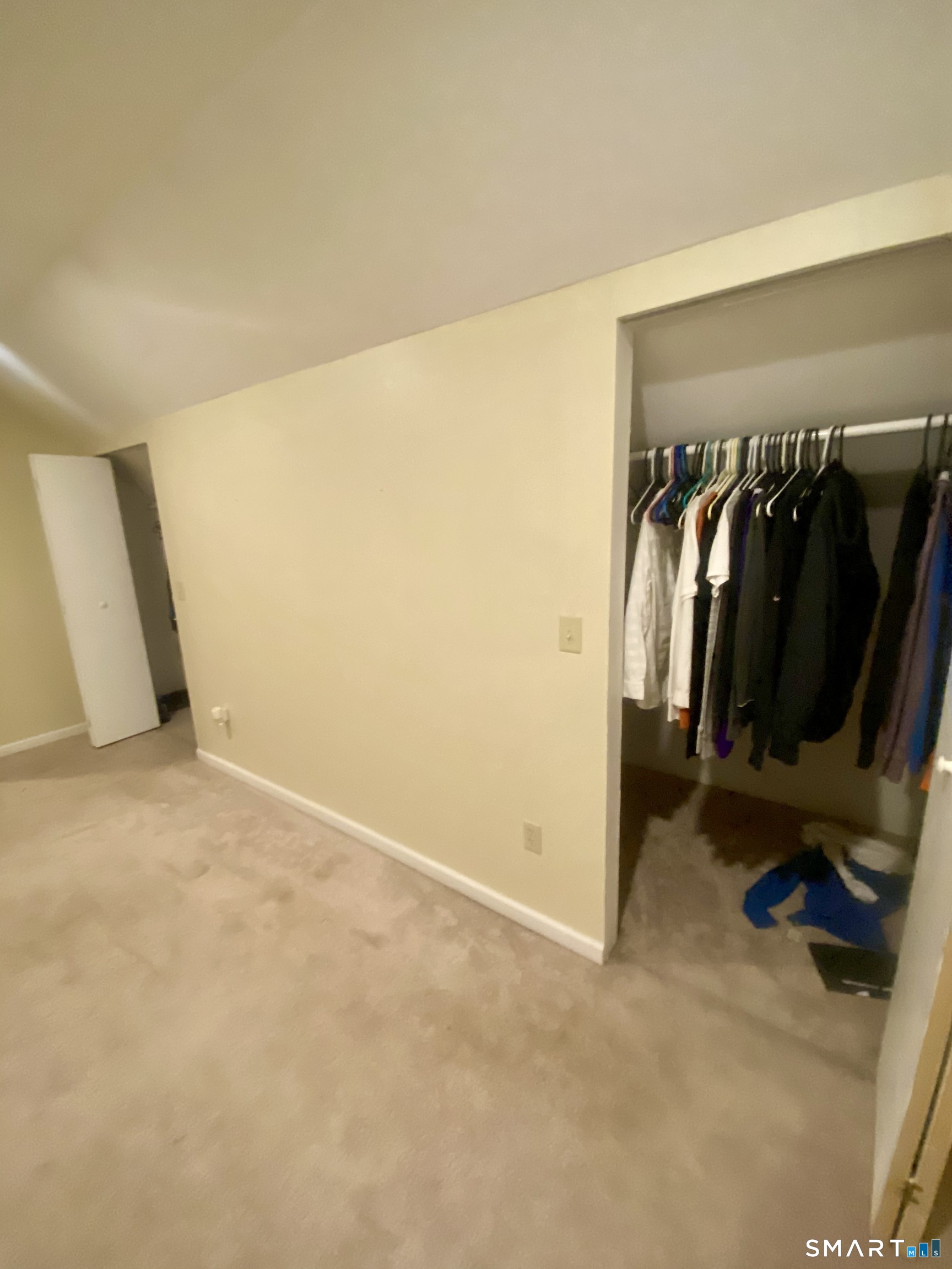1257 Durham Road Wallingford, CT 06492 - Photo 17 of 19 a view of walk in closet with clothes and shoes