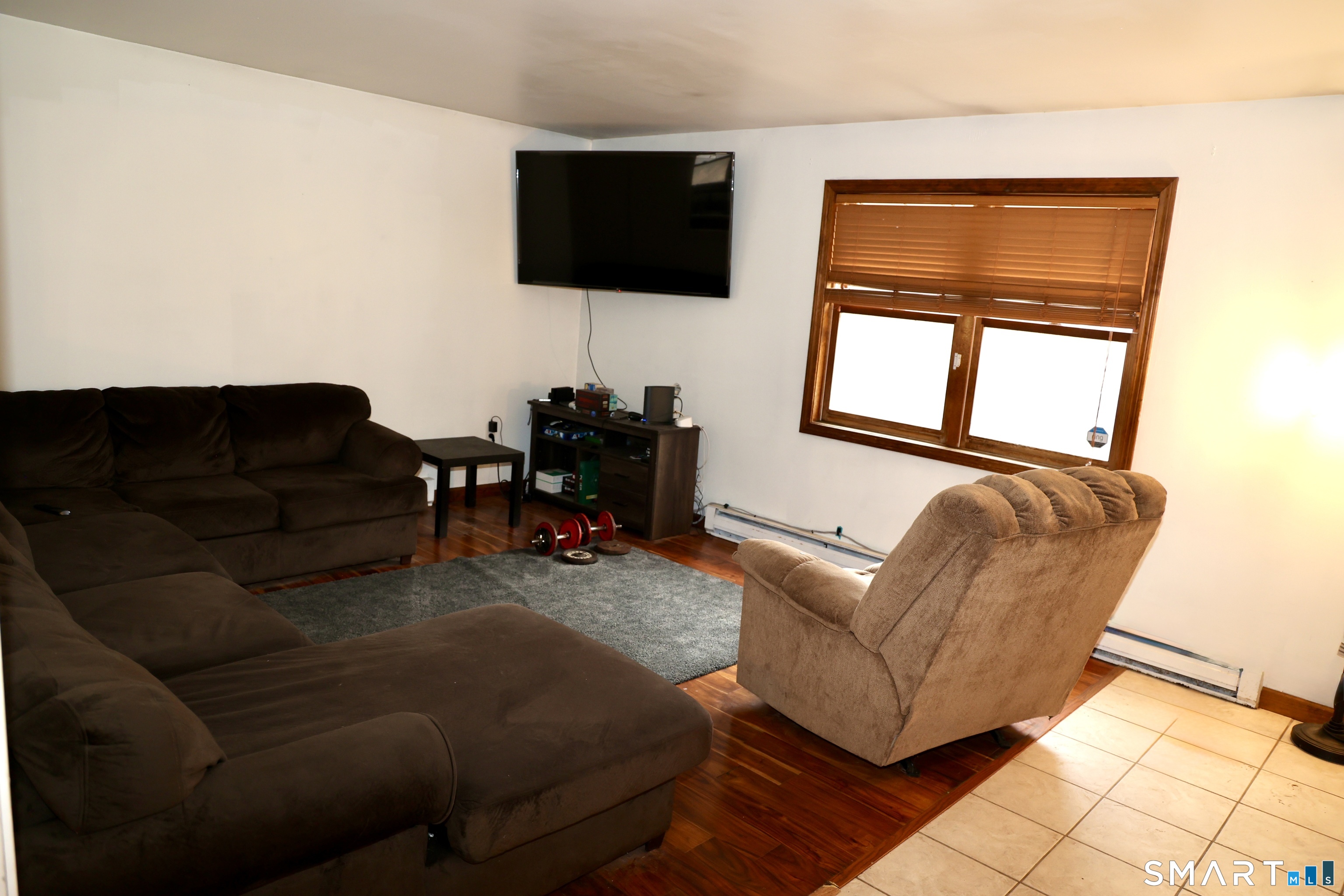 1257 Durham Road Wallingford, CT 06492 - Photo 8 of 19 a living room with furniture and a flat screen tv