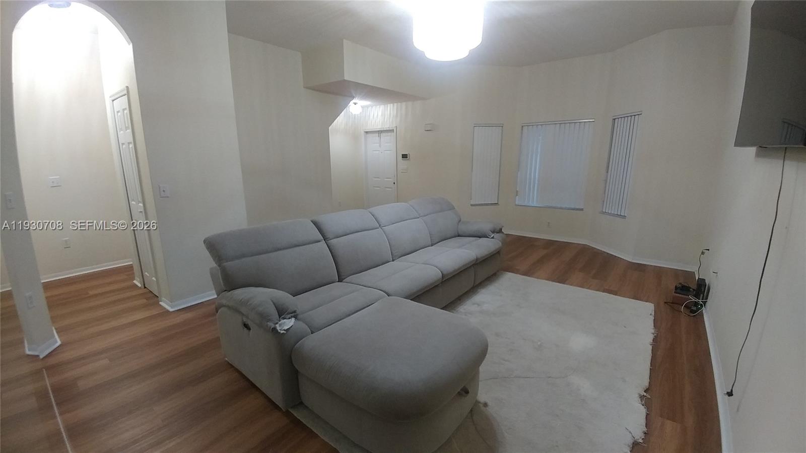 2452 Southeast 19th Court Homestead, FL 33035 - Photo 5 of 10 a living room with furniture and a flat screen tv