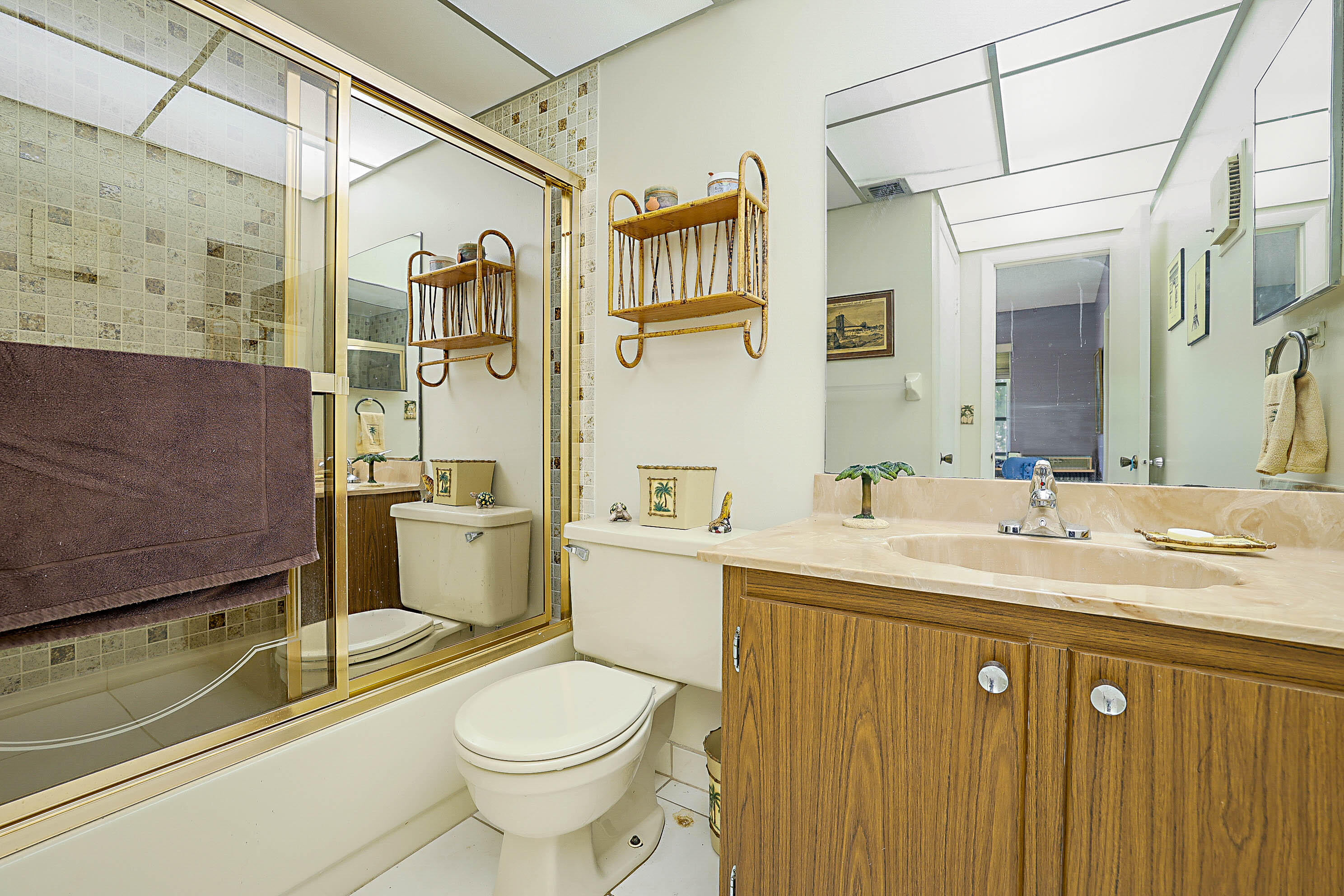 5231 Copperleaf Circle Delray Beach, FL 33484 - Photo 23 of 31 a bathroom with a sink a toilet and shower