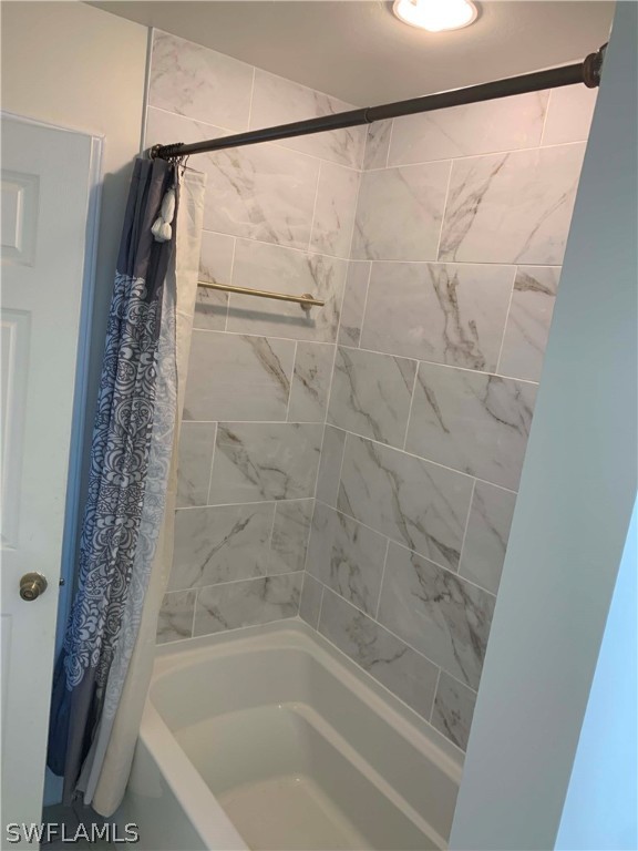 8382 Trillium Road Fort Myers, FL 33967 - Photo 17 of 19 a bathroom with a shower and a bath tub