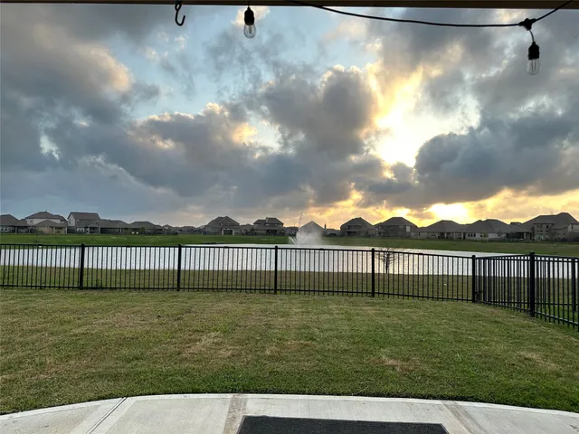 a view of a yard with wooden fence