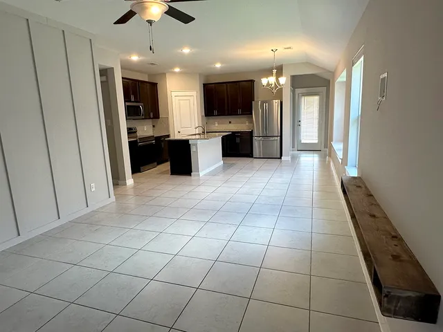 a kitchen with kitchen island granite countertop stainless steel appliances and a center island
