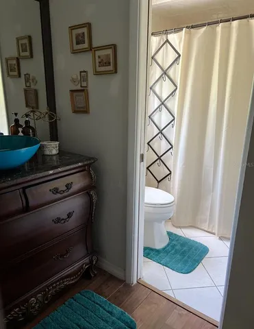 a bathroom with a toilet and a shower curtain