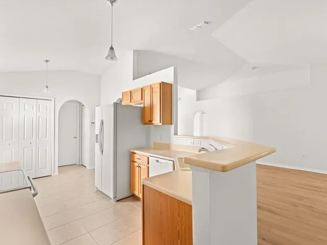 a kitchen with a sink a refrigerator and a stove