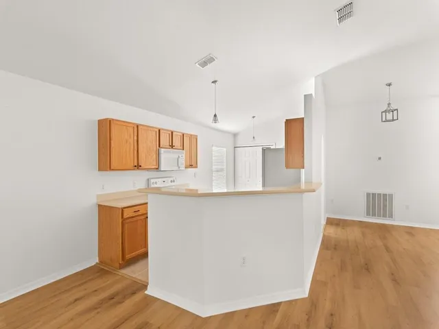 a kitchen with stainless steel appliances a sink and a refrigerator
