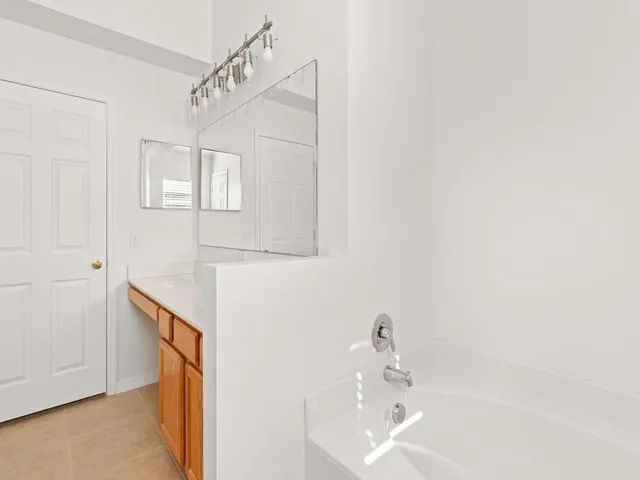 a bathroom with a sink a mirror and a shower