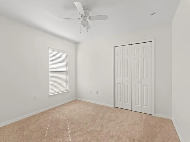 an empty room with windows and closet