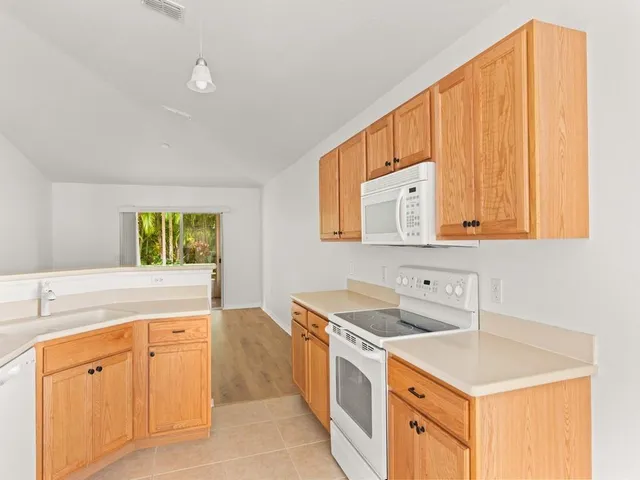 a kitchen that has a sink and a stove