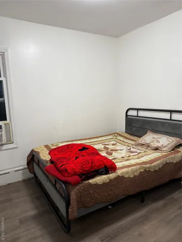 a bedroom with a bed and window