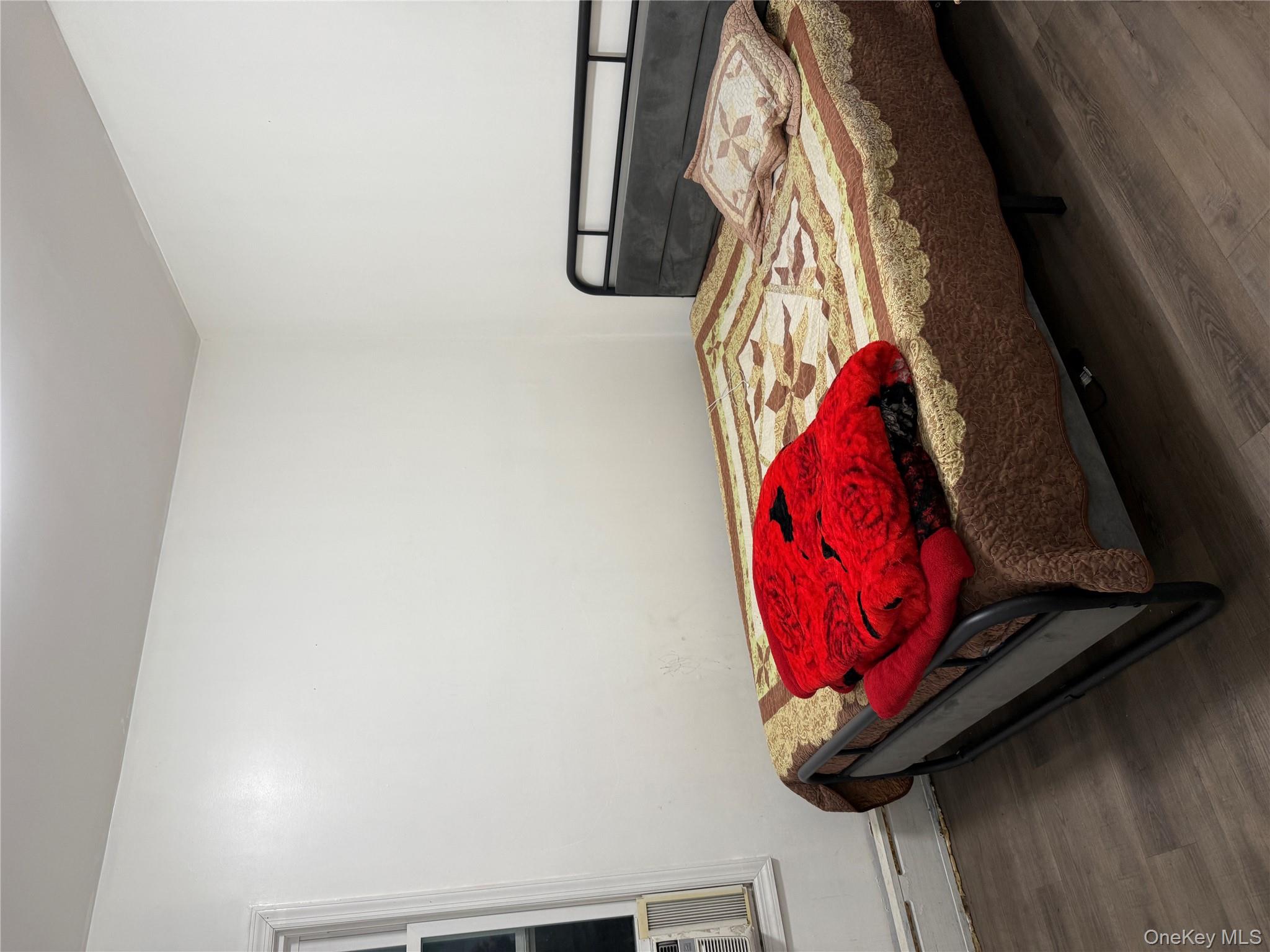 116-13 95th Avenue Queens, NY 11419 - Photo 2 of 7 a bedroom with a bed and window