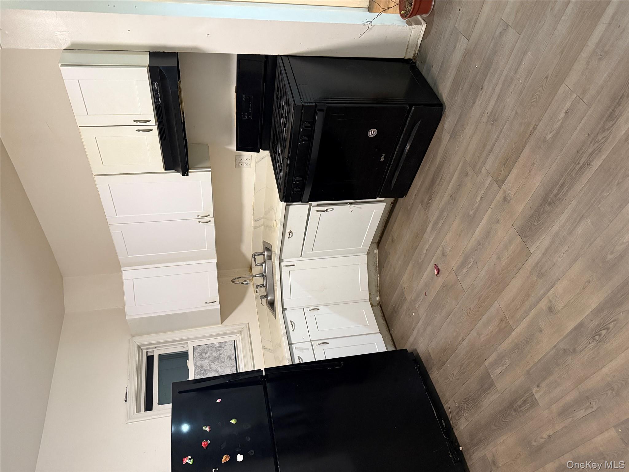 116-13 95th Avenue Queens, NY 11419 - Photo 3 of 7 a kitchen with a sink and a stove