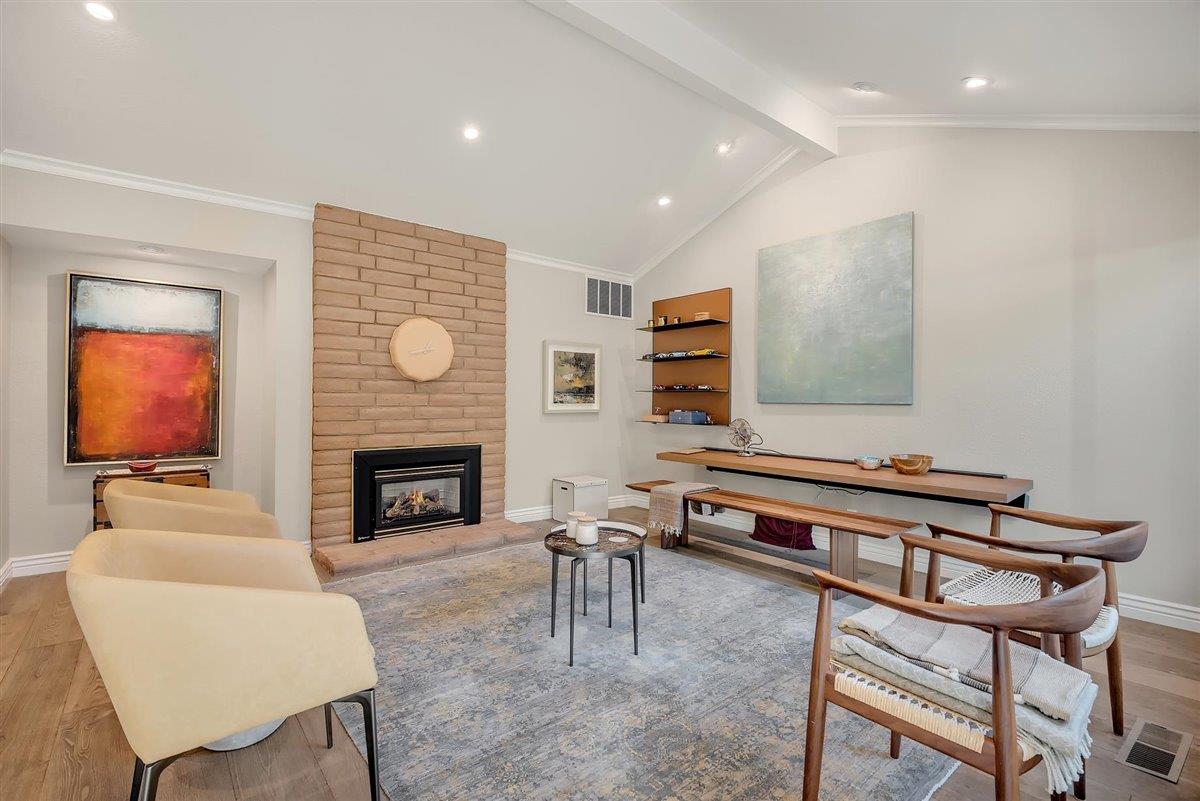 12296 Atrium Circle Saratoga, CA 95070 - Photo 2 of 34 a living room with furniture a flat screen tv and a fireplace