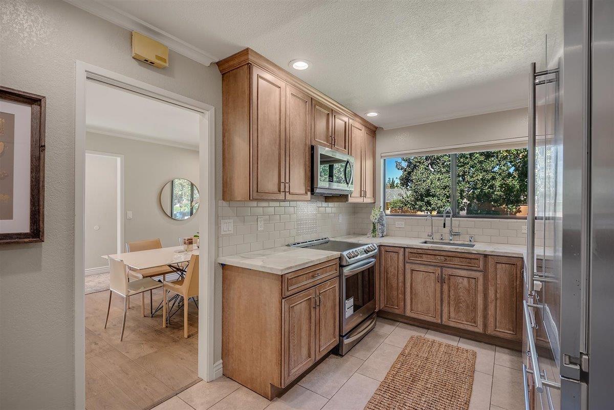 12296 Atrium Circle Saratoga, CA 95070 - Photo 15 of 34 a kitchen with a stove a sink and a refrigerator