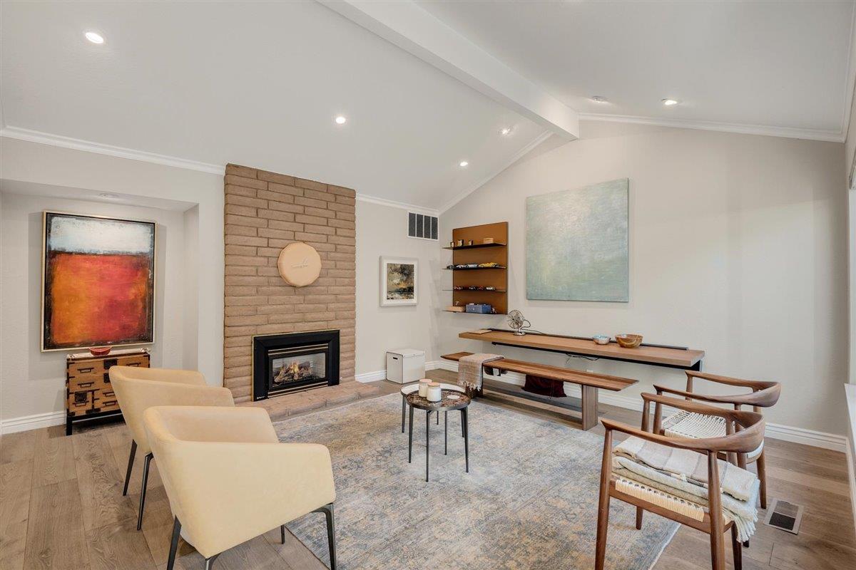 12296 Atrium Circle Saratoga, CA 95070 - Photo 3 of 34 a living room with furniture a fireplace and a flat screen tv