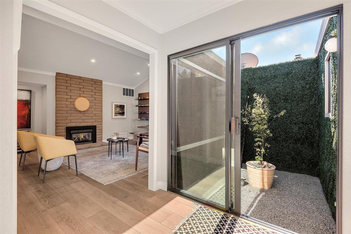 12296 Atrium Circle Saratoga, CA 95070 - Photo 7 of 34 a living room with furniture a lamp and a fireplace