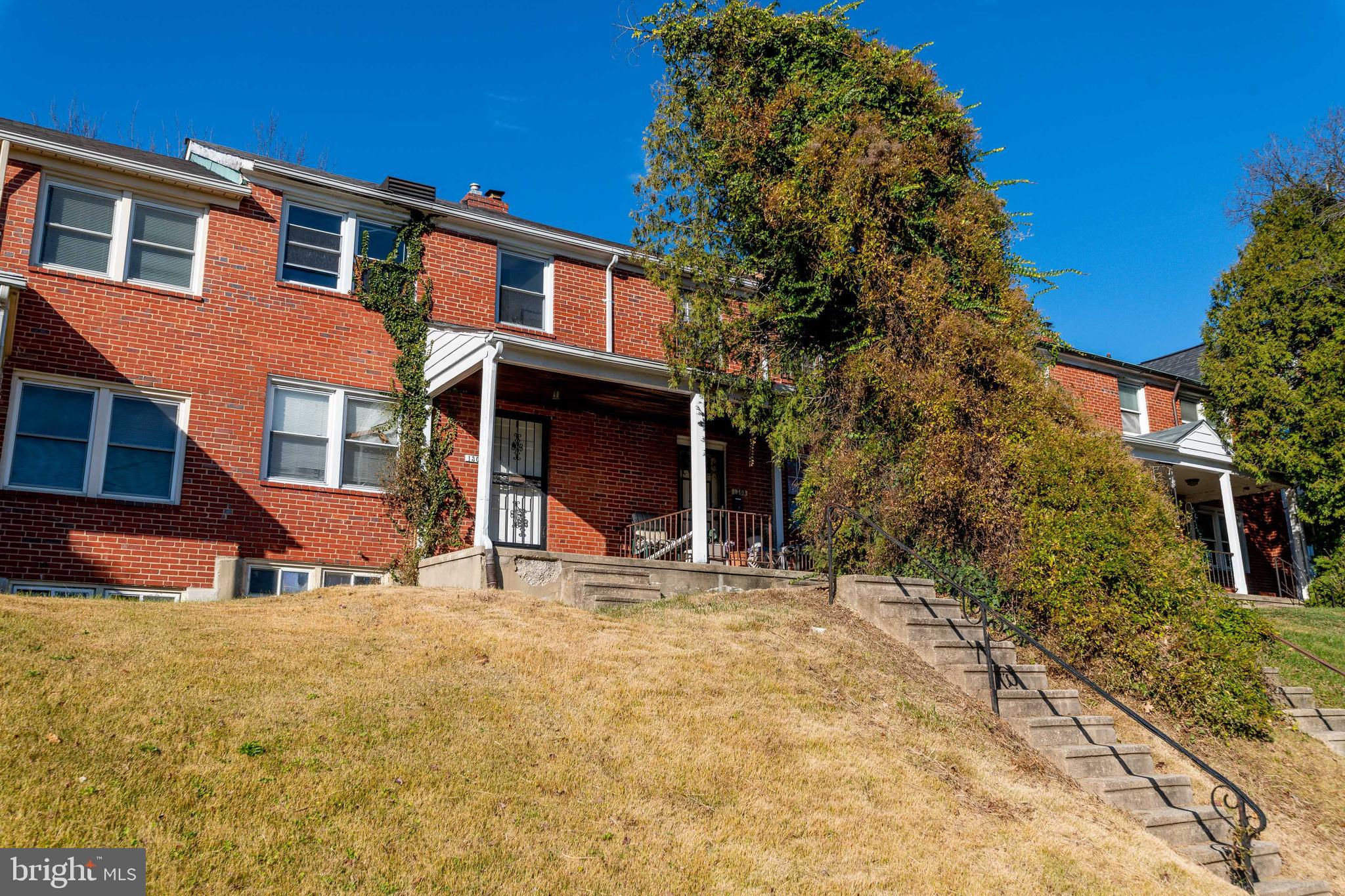 1306 East Cold Spring Lane Baltimore, MD 21239 - Photo 1 of 25 a backyard of a house with large trees