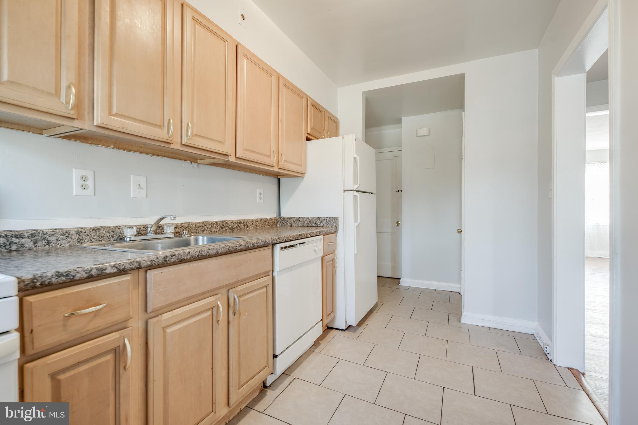 1306 East Cold Spring Lane Baltimore, MD 21239 - Photo 11 of 25 a kitchen with granite countertop white cabinets and stainless steel appliances