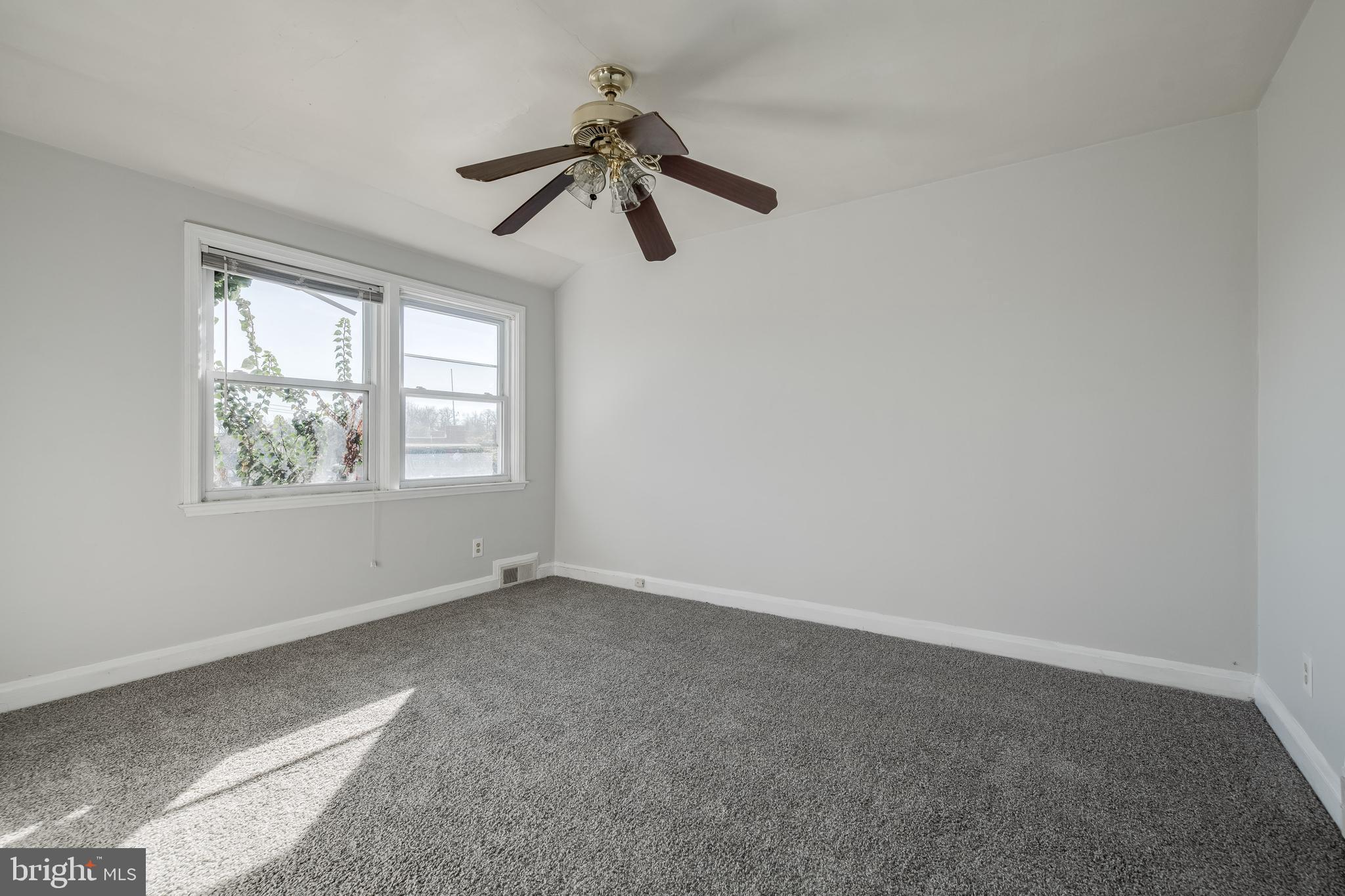 1306 East Cold Spring Lane Baltimore, MD 21239 - Photo 14 of 25 an empty room with windows and fan