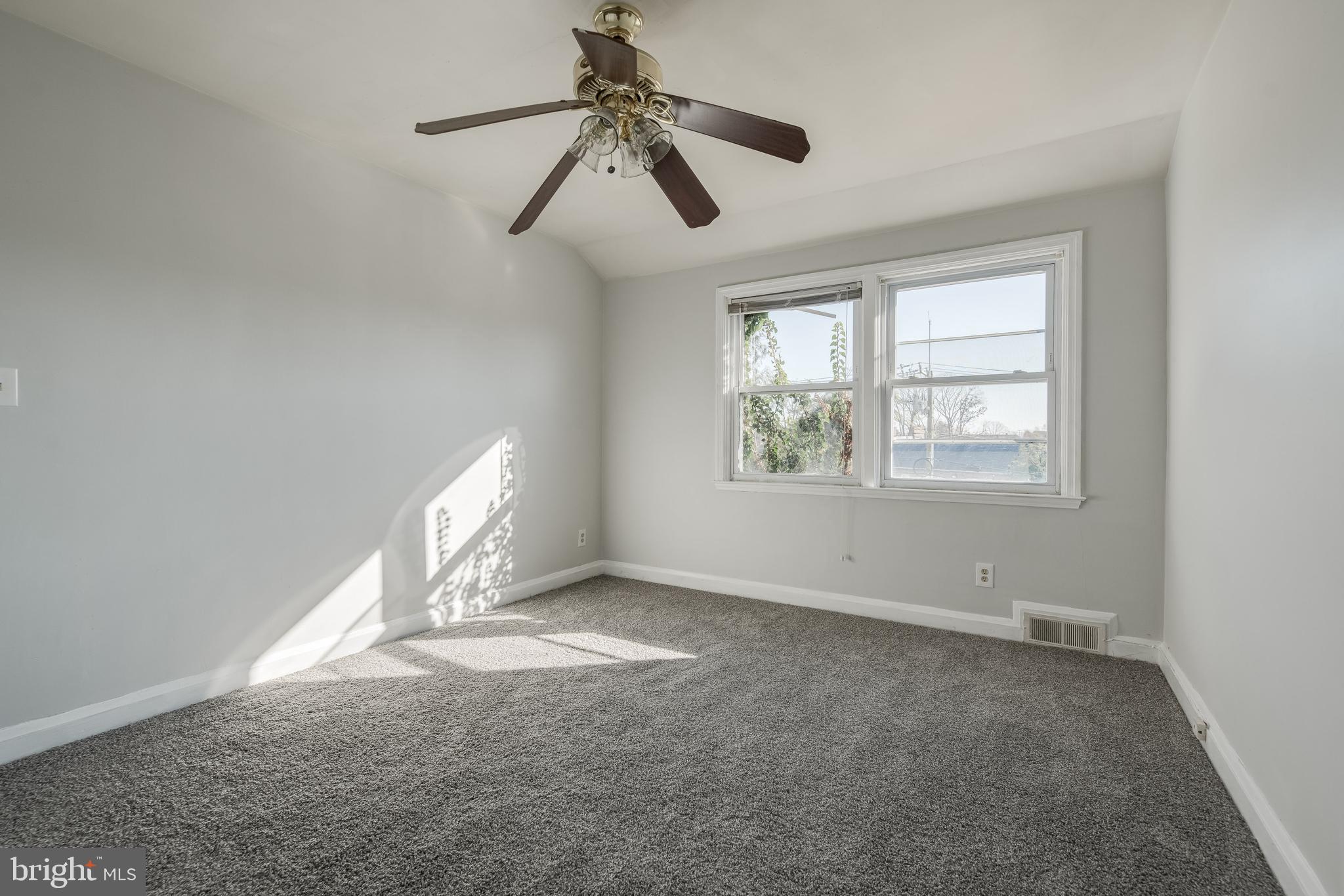 1306 East Cold Spring Lane Baltimore, MD 21239 - Photo 15 of 25 an empty room with windows and fan