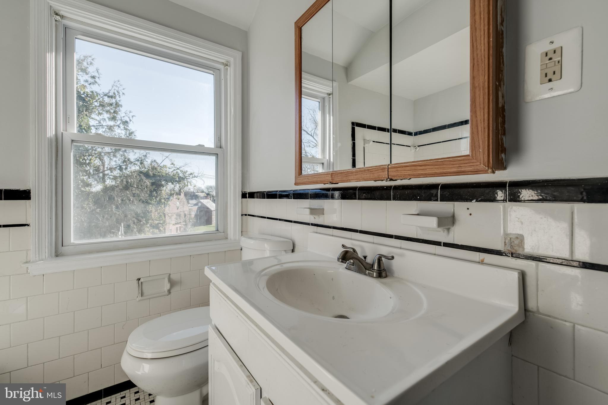 1306 East Cold Spring Lane Baltimore, MD 21239 - Photo 17 of 25 a bathroom with a sink and a toilet