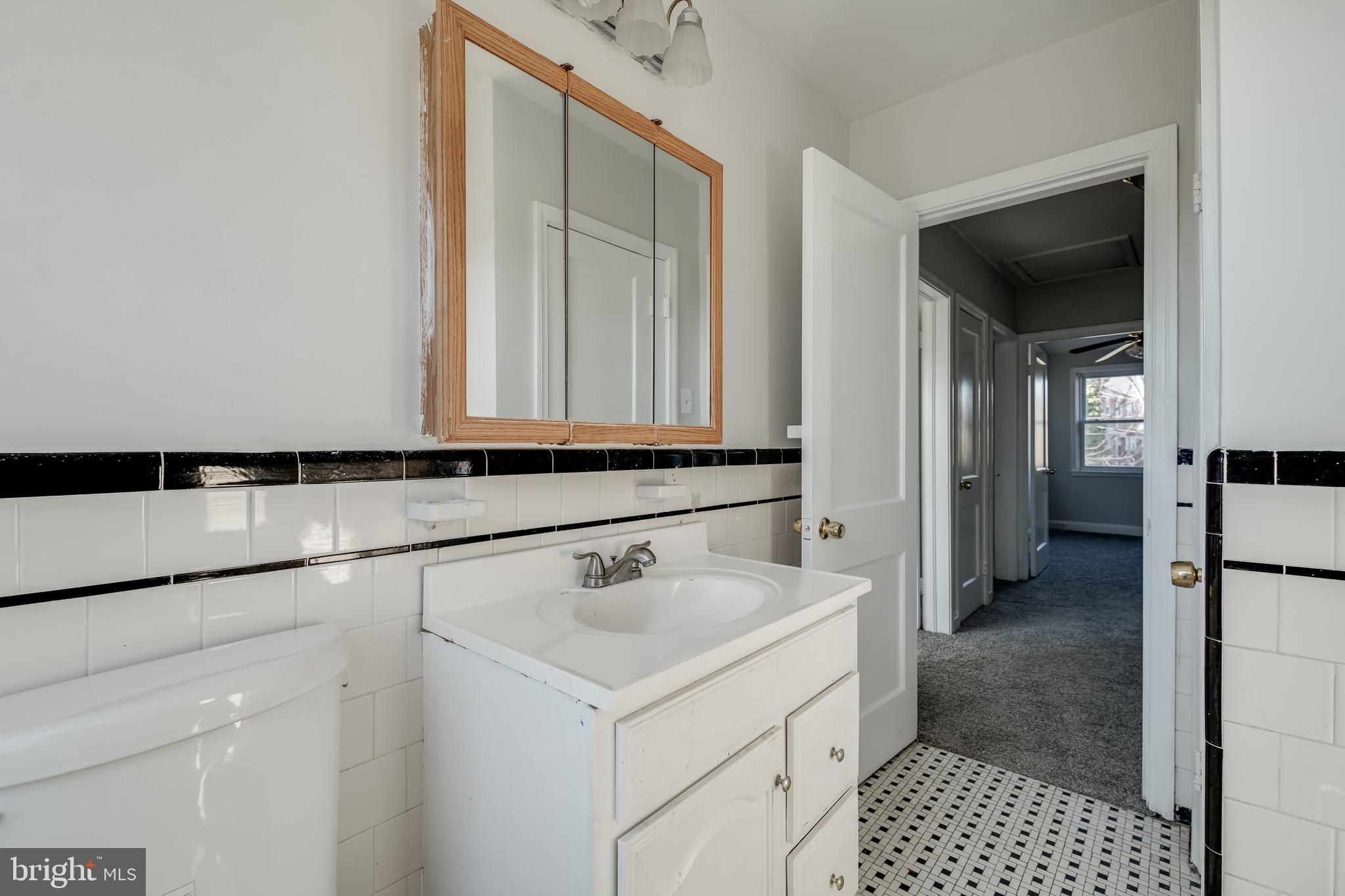 1306 East Cold Spring Lane Baltimore, MD 21239 - Photo 19 of 25 a bathroom with a sink and a mirror