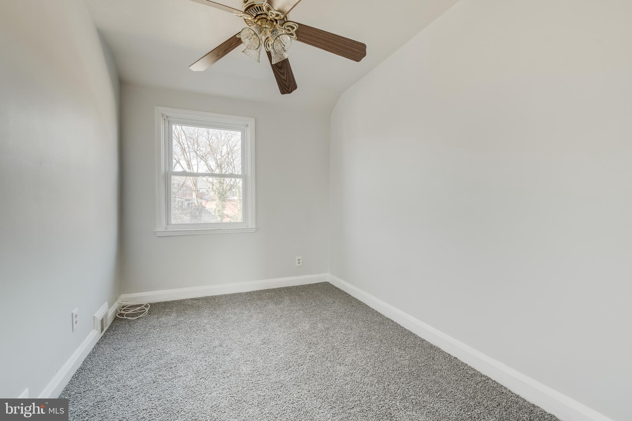 1306 East Cold Spring Lane Baltimore, MD 21239 - Photo 20 of 25 an empty room with a window and a fan