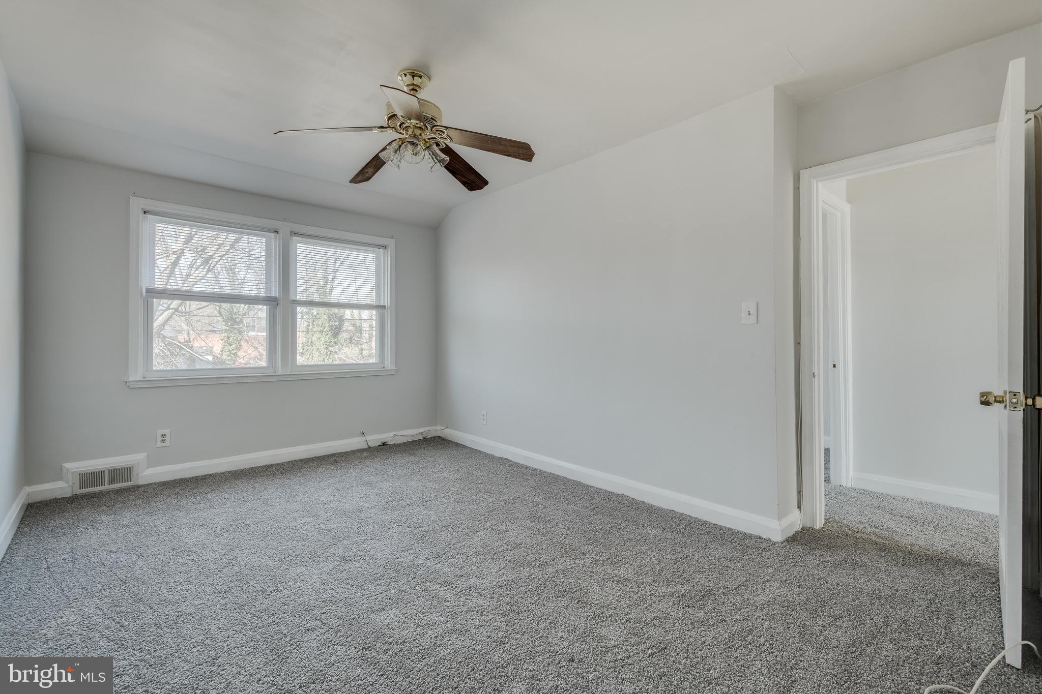 1306 East Cold Spring Lane Baltimore, MD 21239 - Photo 24 of 25 an empty room with windows and fan