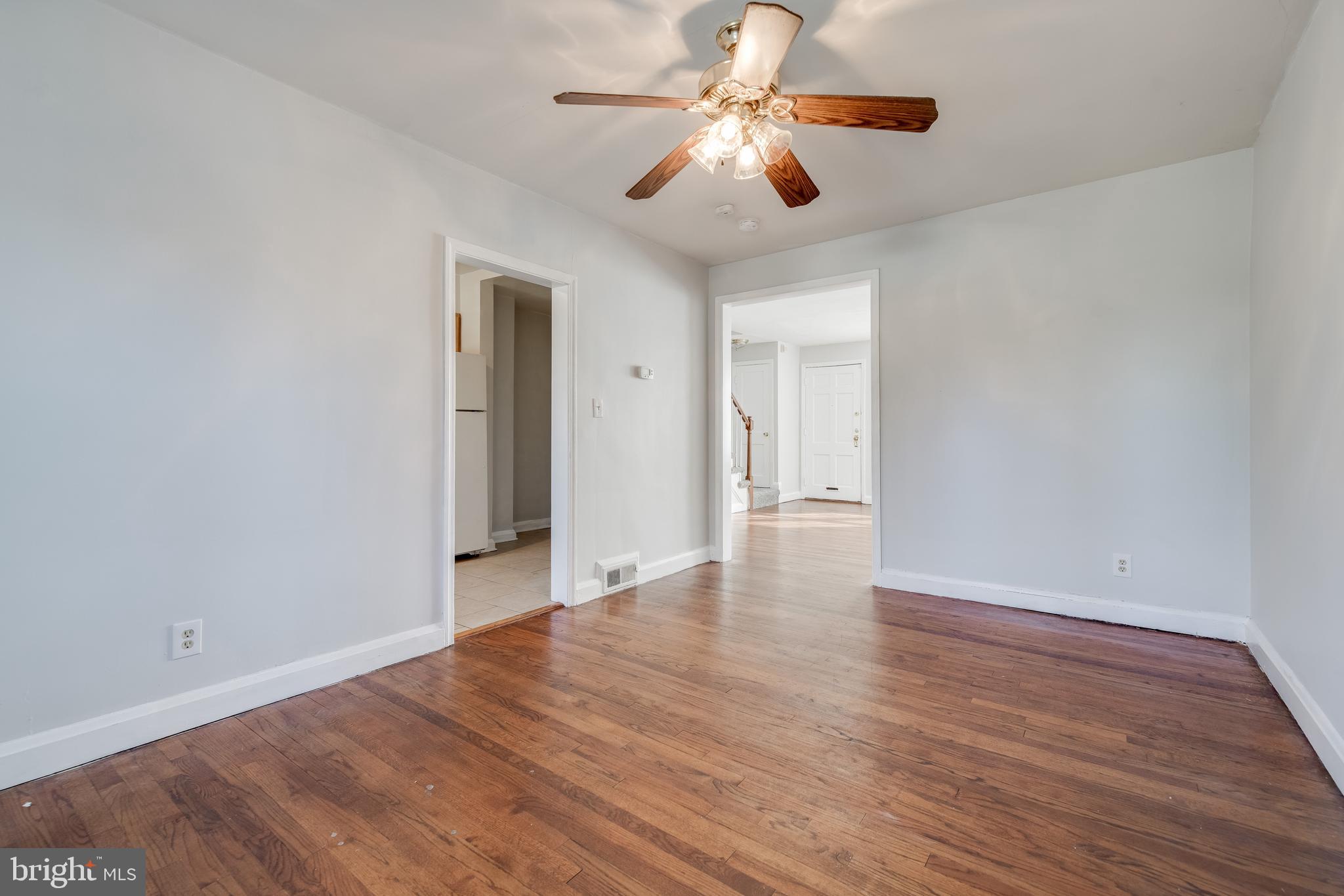 1306 East Cold Spring Lane Baltimore, MD 21239 - Photo 6 of 25 a view of an empty room with wooden floor