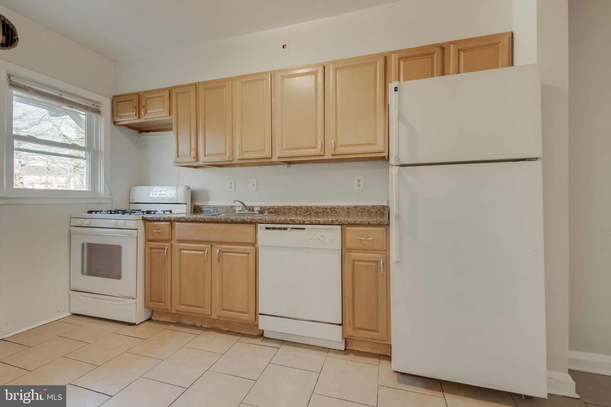 1306 East Cold Spring Lane Baltimore, MD 21239 - Photo 8 of 25 a kitchen with white cabinets and white appliances