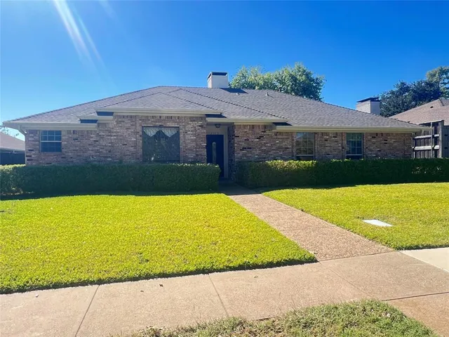a front view of a house with yard