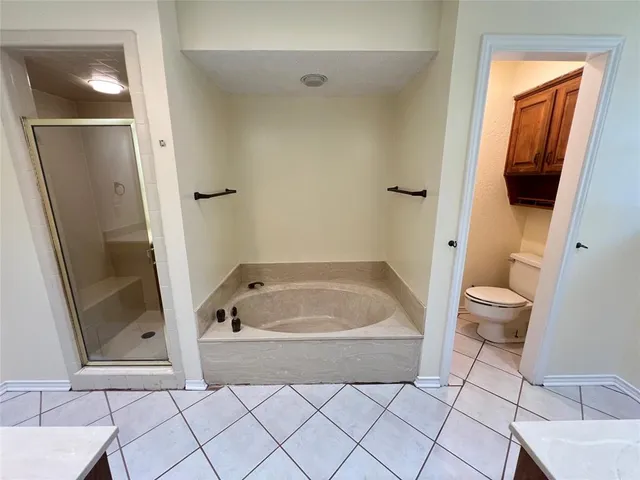 a backyard of a house with table and chairs plants and lake view
