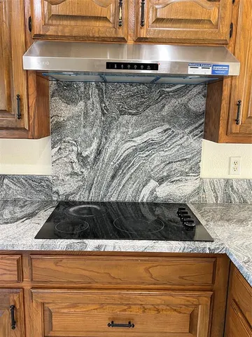 a view of empty room with wooden floor and fireplace