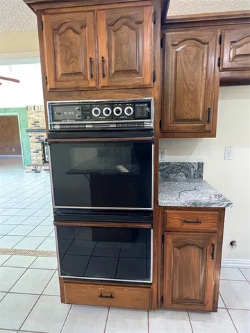 a view of a hallway with a chandelier fan and windows