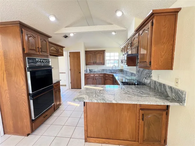 a room with a cabinets and a stove top oven