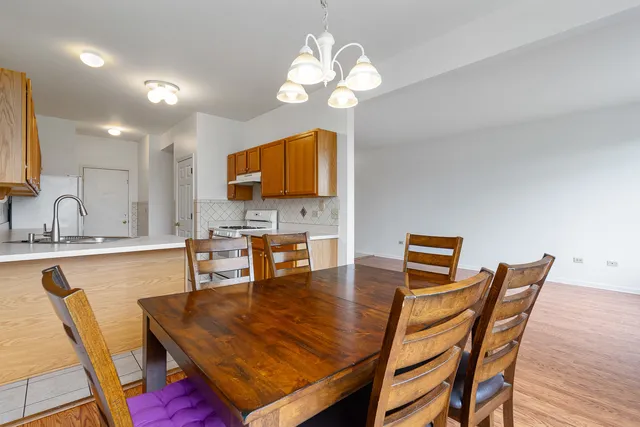 a view of a dining room with furniture and a chandelier