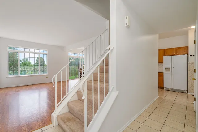 a view of a hallway with wooden floor and entryway