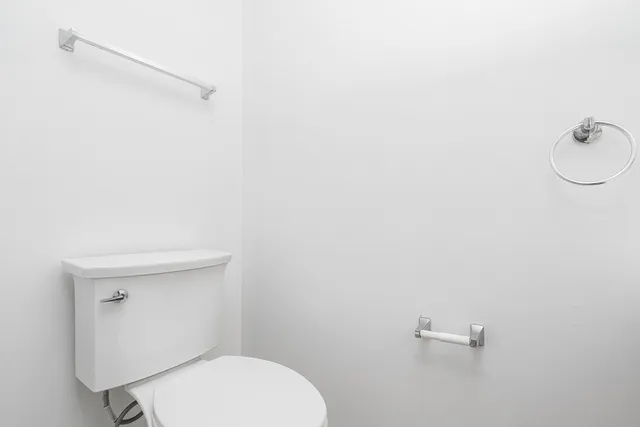 a white toilet sitting next to a white sink