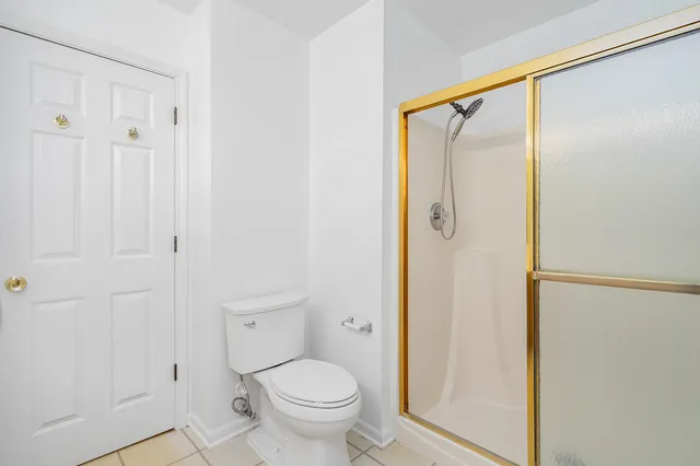 a bathroom that has a shower toilet