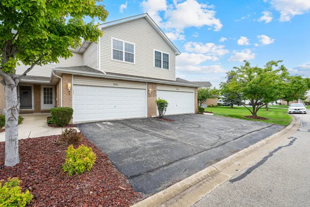 a front view of a house with a yard and a garage