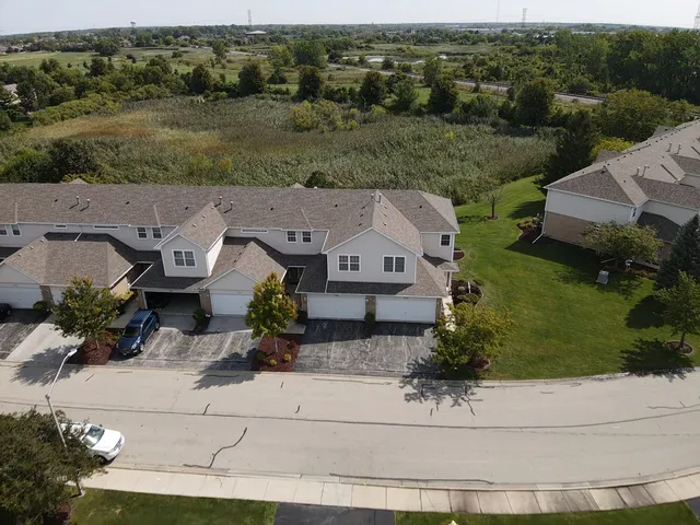 an aerial view of a house with a yard